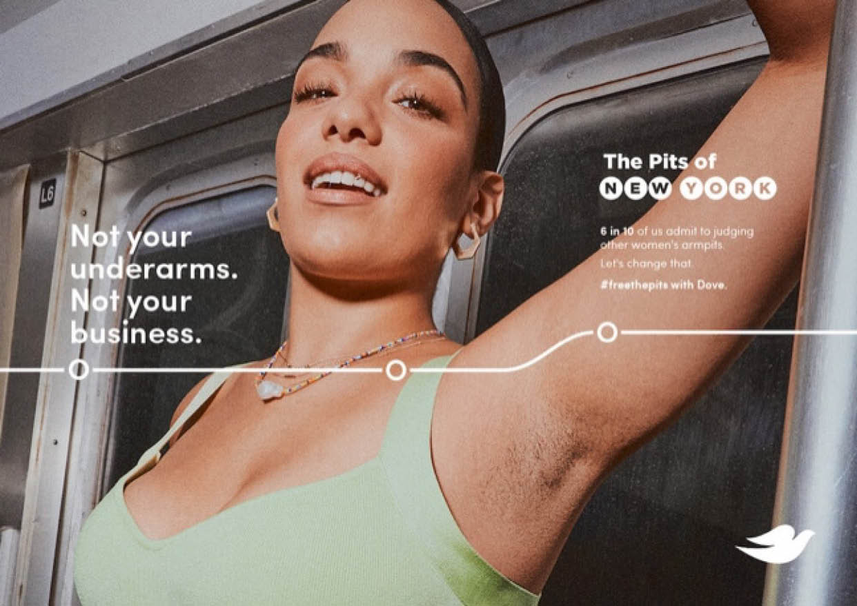 A person wearing a green tank top raises an arm to show an unshaved armpit with text advocating for acceptance of natural underarms and challenging societal norms. Description generated by AI